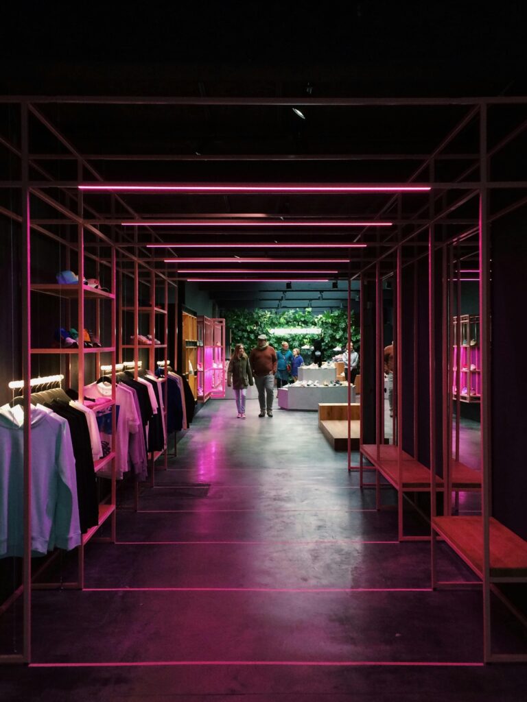 pexels photo 1020370 1020370 Interior of a modern clothing store in Antwerp, featuring neon pink lights and a sleek design.
