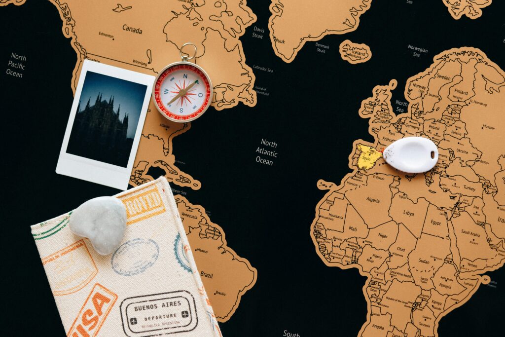 pexels photo 7235907 7235907 Flat lay of travel items including a map, compass, and polaroid for adventure planning.