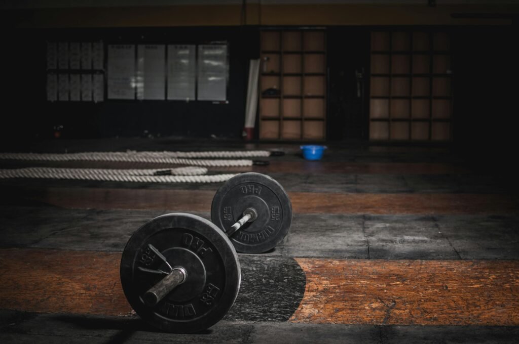 pexels photo 1552252 1552252 A lone barbell rests in an empty, dimly lit gym, emphasizing strength and solitude.