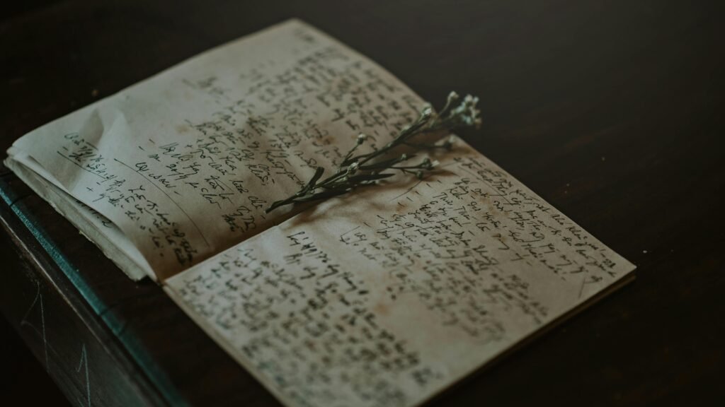 pexels photo 771322 771322 A vintage notebook with handwritten notes and delicate flowers, evoking nostalgia and warmth.